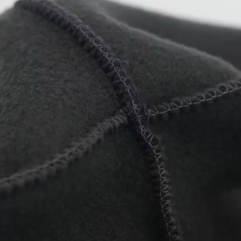 Close-up of a single green leaf against a white background.